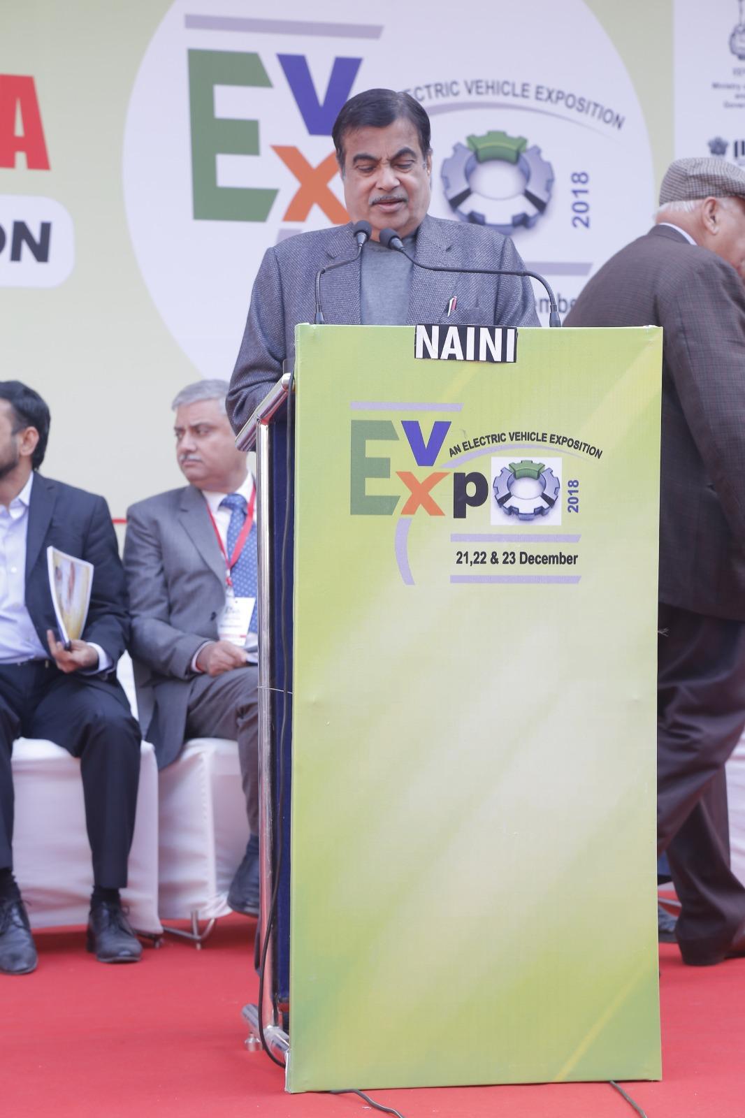 Speaker addressing the audience from an EV-Expo podium at a previous exhibition